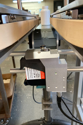 New Printer Mounting Kit for Bottomless Conveyor Automates Bottle Bottom Coding